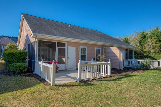 rear view of house with a yard