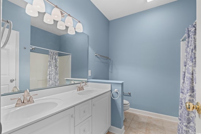 bathroom with double sink, toilet, tile floors, and oversized vanity