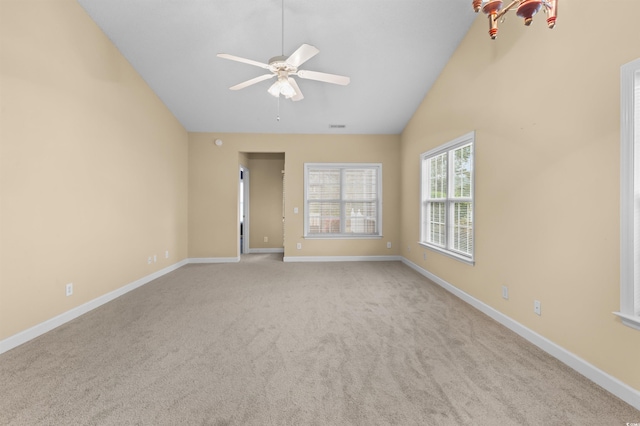 carpeted spare room with high vaulted ceiling and ceiling fan