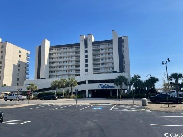 view of building exterior with uncovered parking