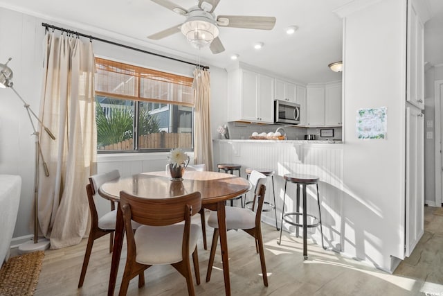 dining room featuring ceiling fan and light hardwood / wood-style floors