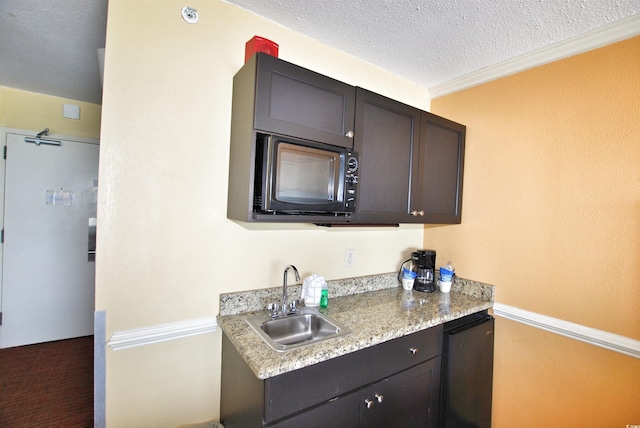 kitchen featuring a textured ceiling, sink, dark brown cabinets, and light stone countertops