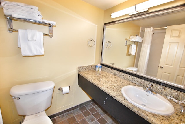 bathroom with vanity, tile floors, and toilet