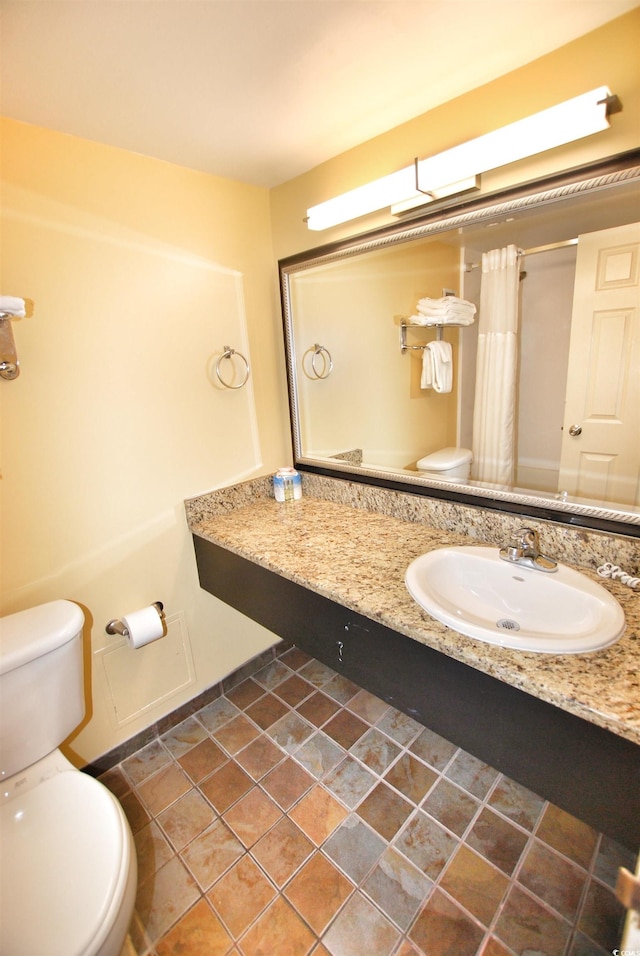 bathroom with oversized vanity, toilet, and tile flooring