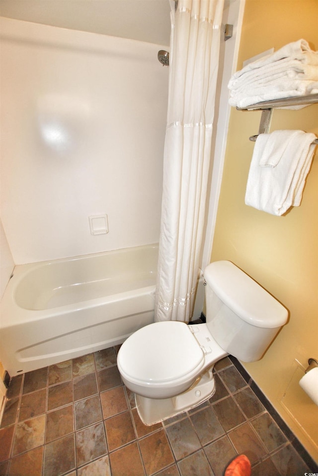 bathroom featuring shower / tub combo, toilet, and tile flooring