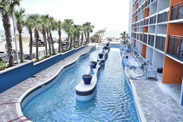 view of pool featuring a water view