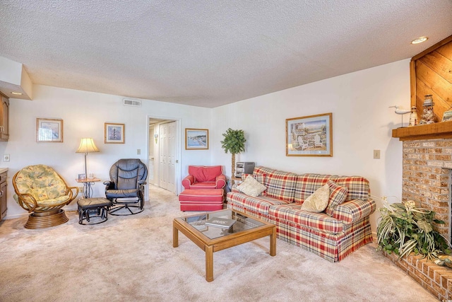 carpeted living room with a textured ceiling and a brick fireplace