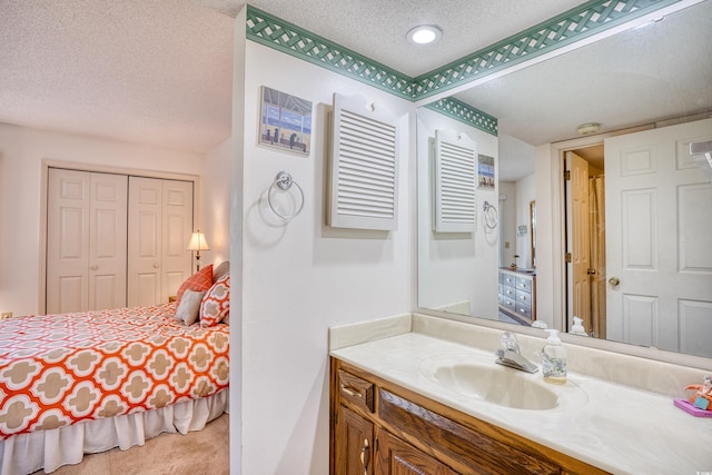 bathroom with vanity and a textured ceiling