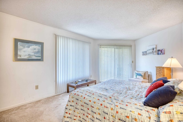 carpeted bedroom featuring a textured ceiling