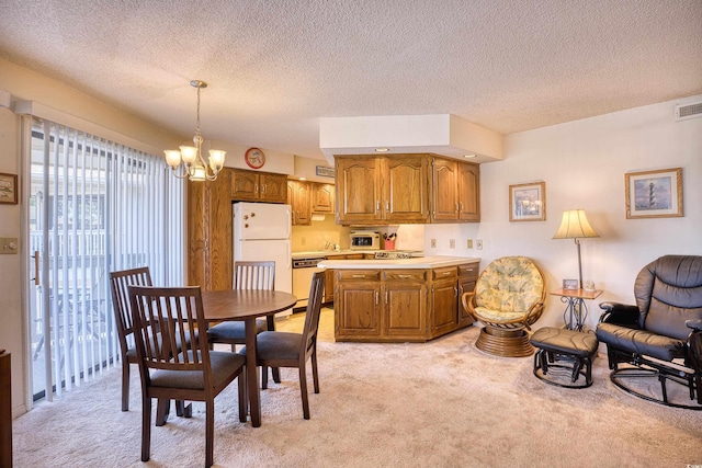 dining space with a textured ceiling, light carpet, and an inviting chandelier