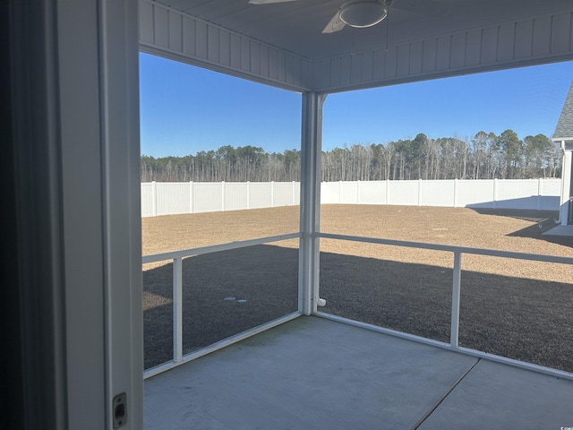 unfurnished sunroom with ceiling fan