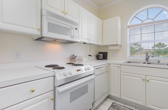 kitchen with light tile floors, ornamental molding, white appliances, white cabinetry, and sink