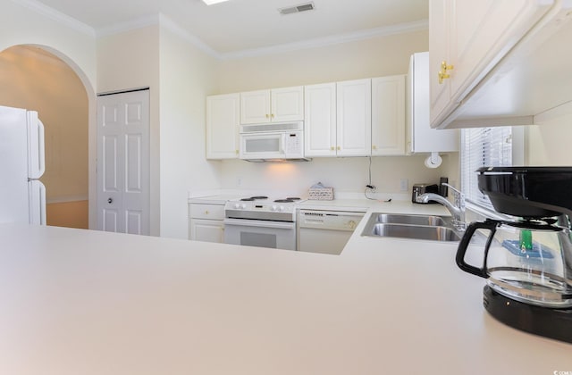 kitchen with white cabinets, white appliances, sink, and crown molding