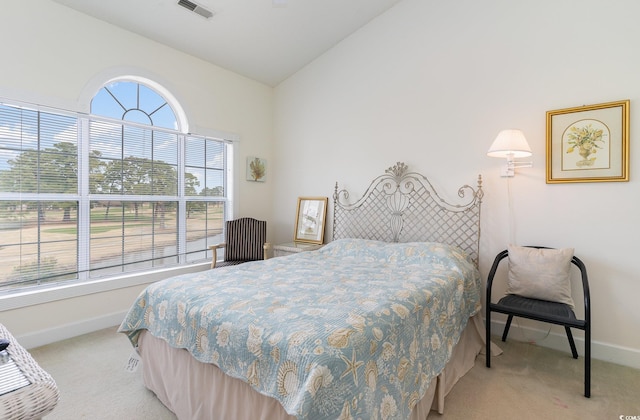 carpeted bedroom with vaulted ceiling