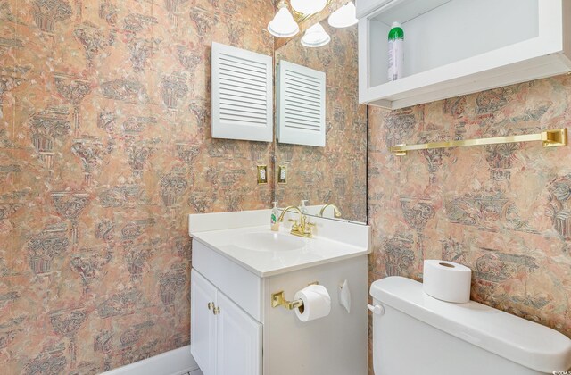 bathroom with toilet and large vanity