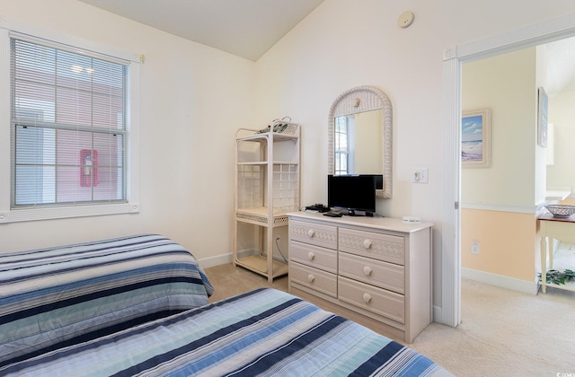 carpeted bedroom with vaulted ceiling