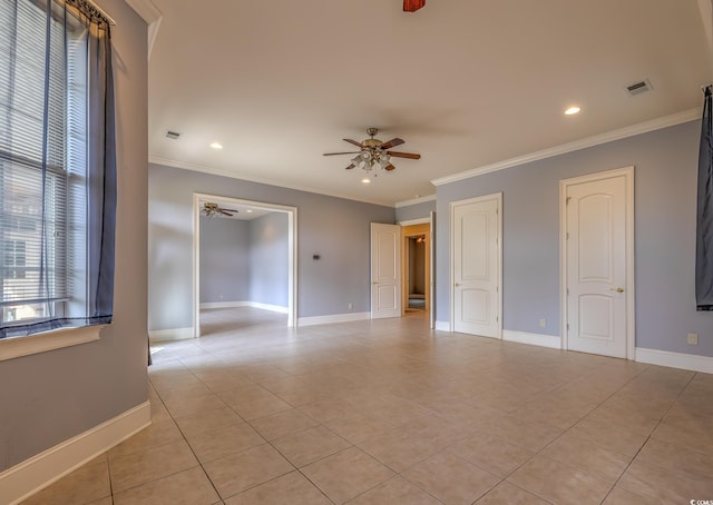 tiled spare room featuring crown molding and ceiling fan