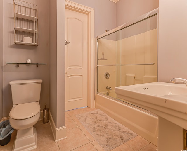 bathroom with shower / bath combination with glass door, toilet, and tile floors