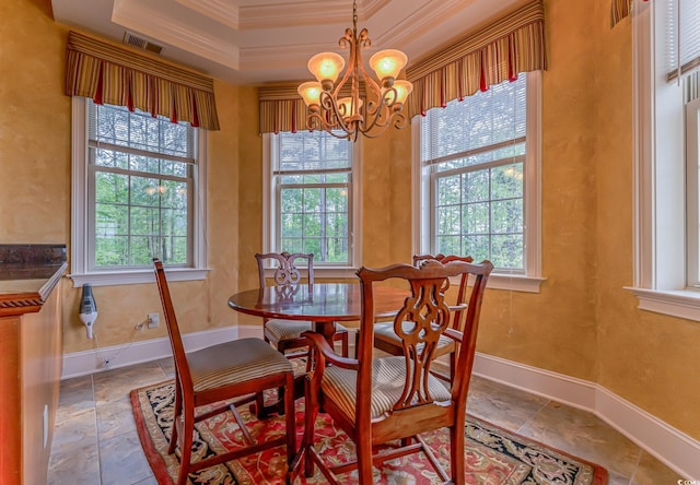 dining room featuring a notable chandelier, ornamental molding, a tray ceiling, and light tile floors