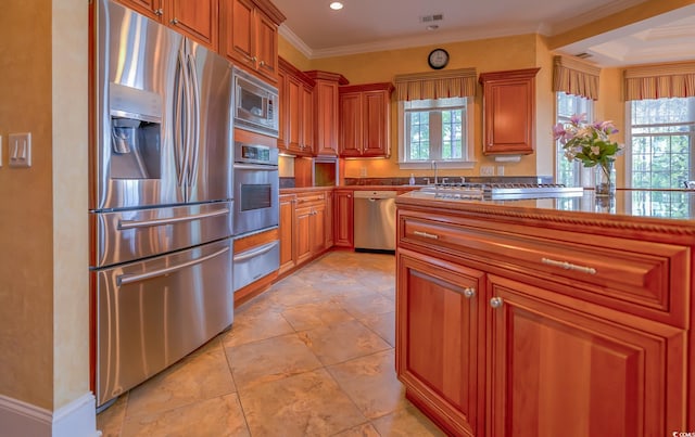 kitchen featuring crown molding, light tile flooring, and stainless steel appliances