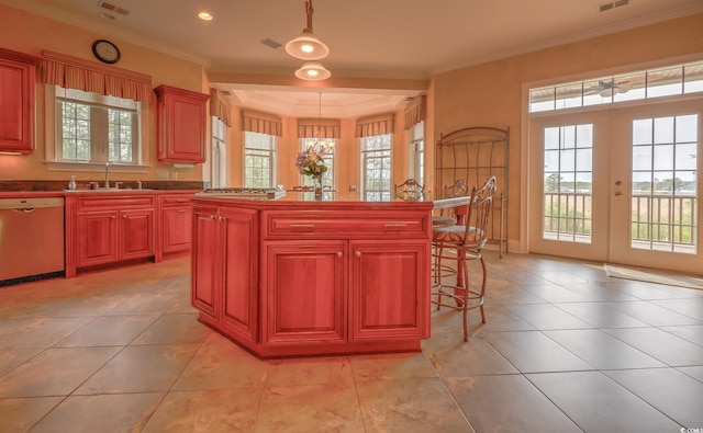 kitchen with decorative light fixtures, a kitchen bar, dishwasher, french doors, and ornamental molding