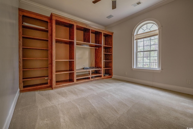 unfurnished room featuring ceiling fan, ornamental molding, light carpet, and plenty of natural light