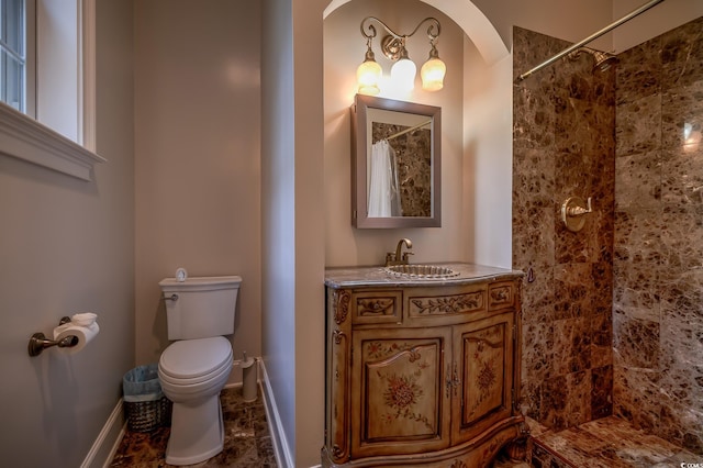 bathroom with curtained shower, vanity, toilet, and tile floors