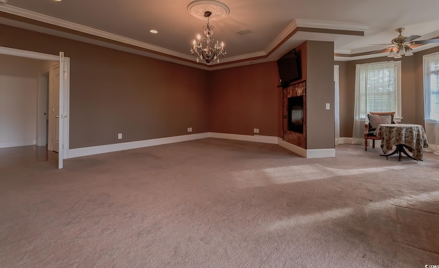 empty room featuring crown molding, a raised ceiling, light carpet, and ceiling fan with notable chandelier