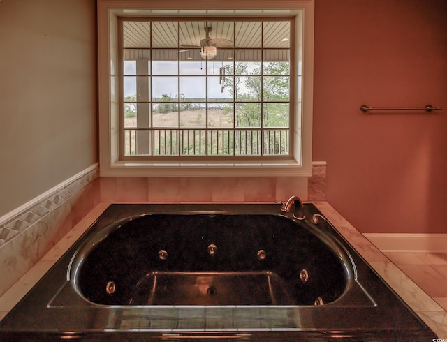 bathroom with a tub and ceiling fan