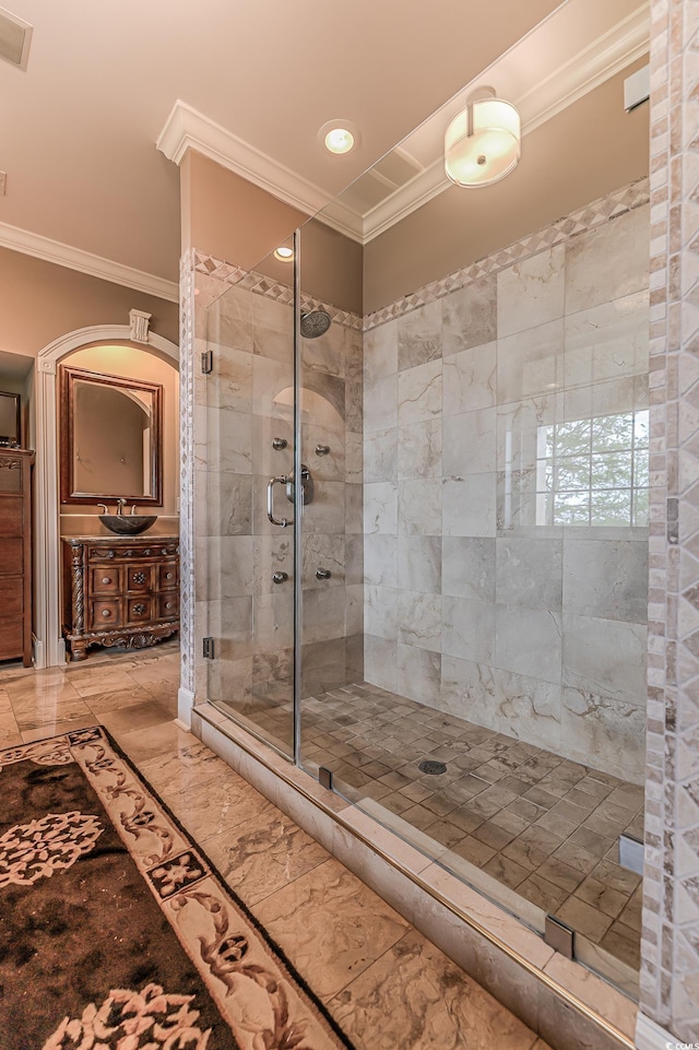 bathroom featuring tile floors, walk in shower, ornamental molding, and vanity