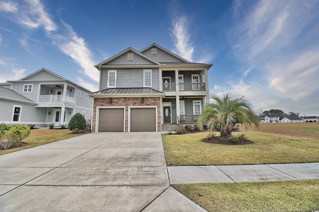 view of front of house featuring a garage, a balcony, and a front lawn