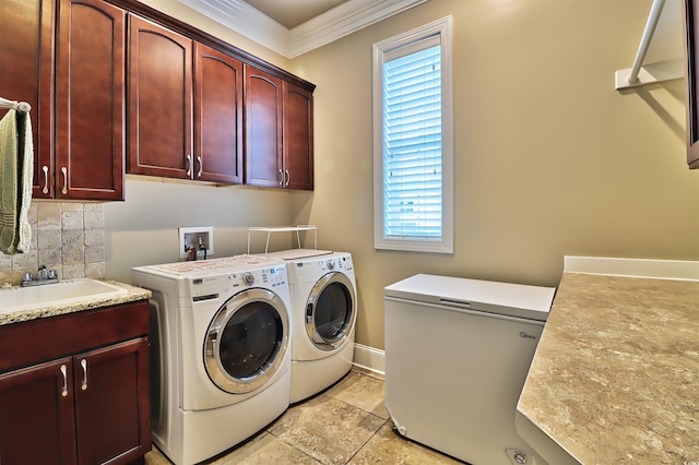 laundry area with cabinets, a wealth of natural light, crown molding, and washer and clothes dryer