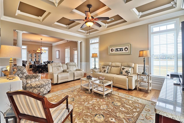 living room with a wealth of natural light, hardwood / wood-style flooring, crown molding, and coffered ceiling