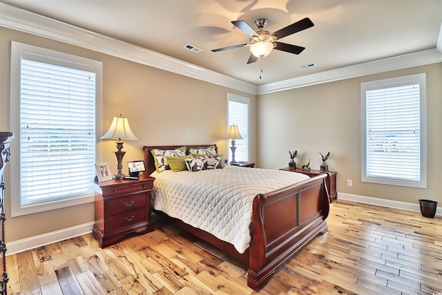 bedroom featuring crown molding, light hardwood / wood-style flooring, and ceiling fan