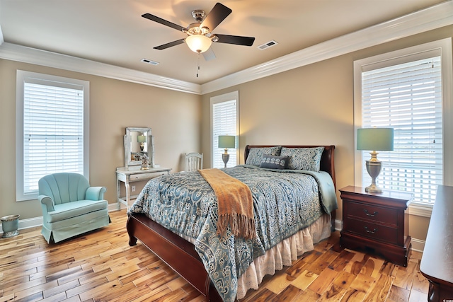 bedroom with ceiling fan, crown molding, hardwood / wood-style flooring, and multiple windows