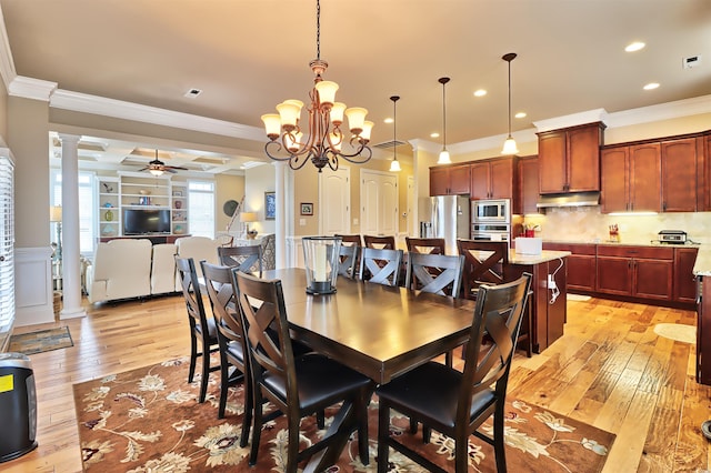 dining space with ceiling fan with notable chandelier, crown molding, light hardwood / wood-style flooring, and decorative columns