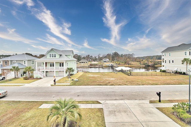 view of yard with a water view and a garage