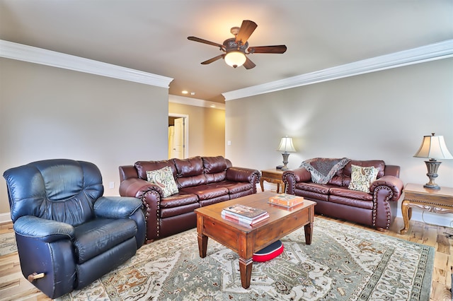 living room featuring hardwood / wood-style floors, ceiling fan, and crown molding