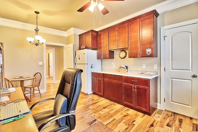 kitchen featuring pendant lighting, ceiling fan with notable chandelier, crown molding, white fridge, and light hardwood / wood-style floors