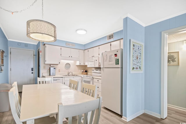 kitchen featuring light hardwood / wood-style floors, sink, white cabinets, white appliances, and crown molding