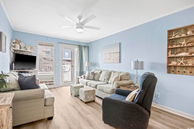 living room featuring crown molding, ceiling fan, and light hardwood / wood-style flooring