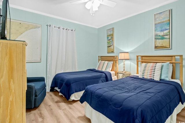 bedroom featuring light wood-type flooring, ceiling fan, and crown molding