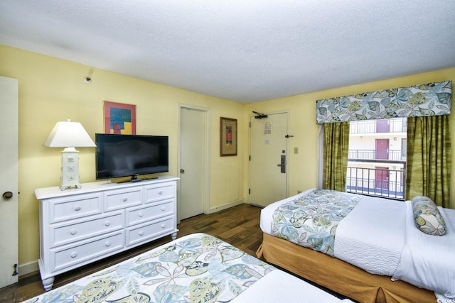 bedroom featuring dark hardwood / wood-style floors and a textured ceiling