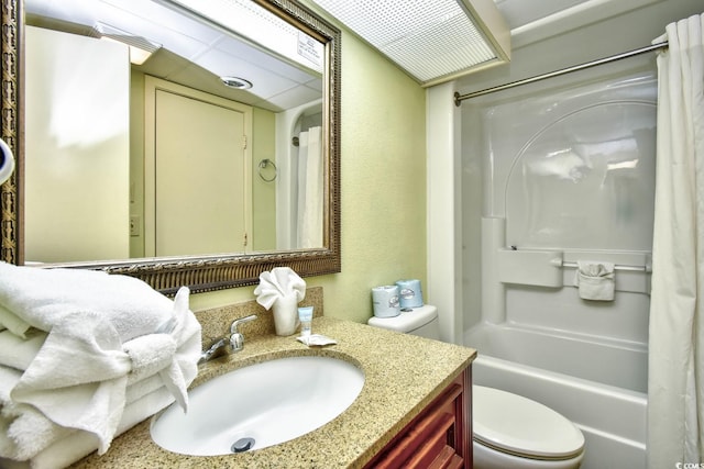 full bathroom with toilet, vanity with extensive cabinet space, and shower / tub combo