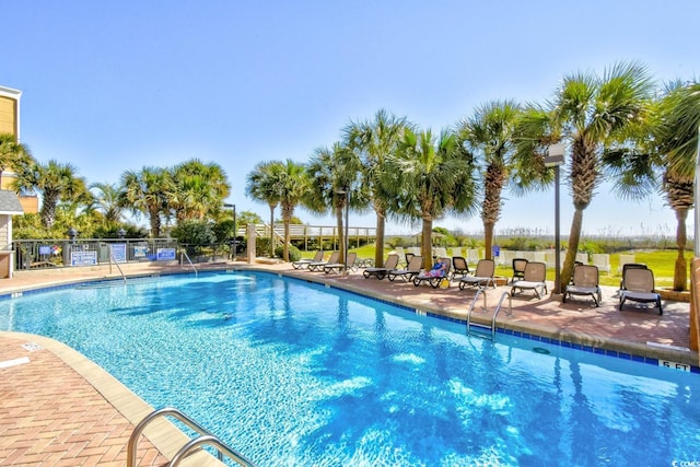 view of swimming pool with a patio area