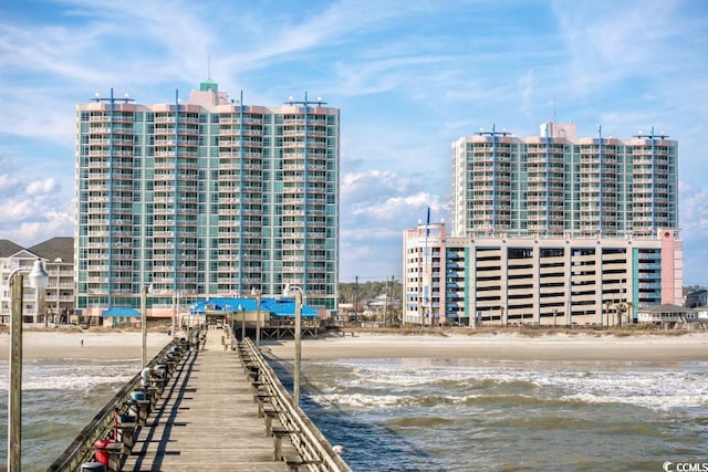 view of building exterior featuring a beach view and a water view