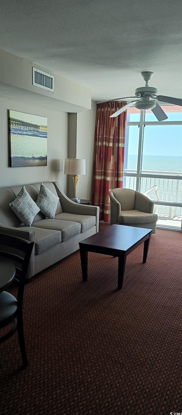 carpeted living room featuring ceiling fan