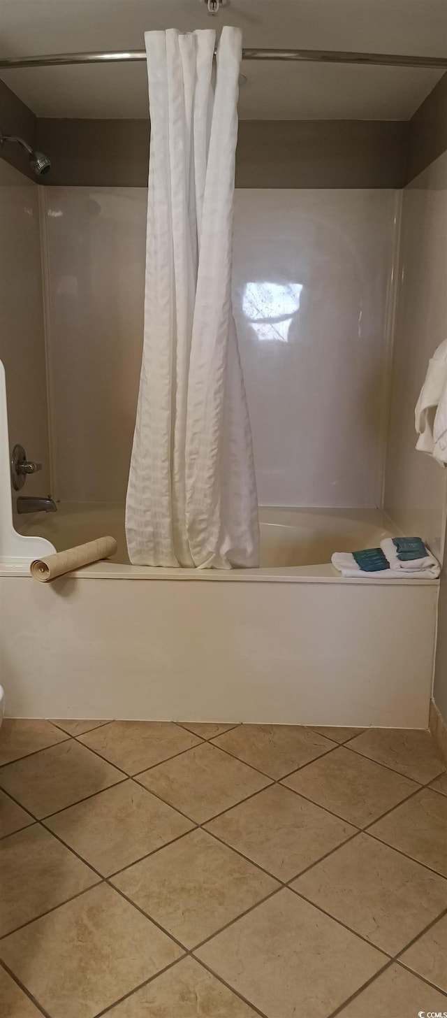 bathroom with tile floors and shower / bath combo with shower curtain