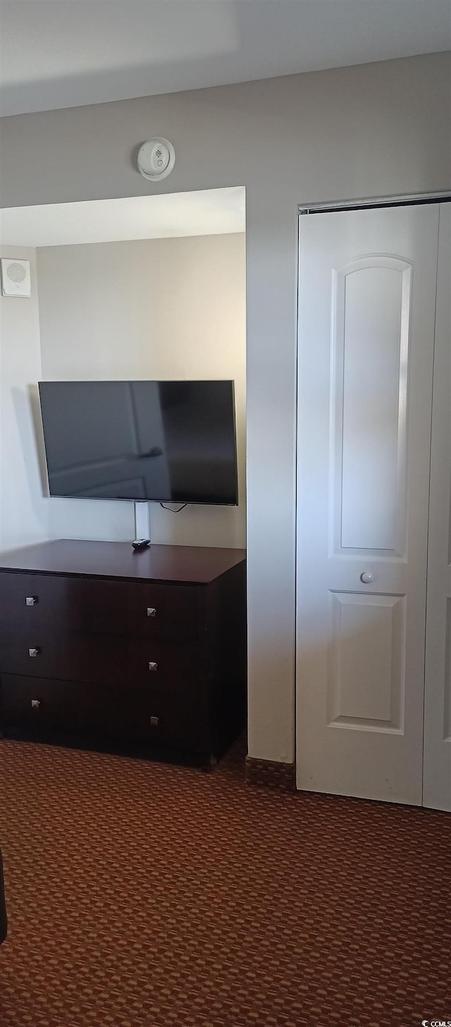 unfurnished office featuring dark colored carpet