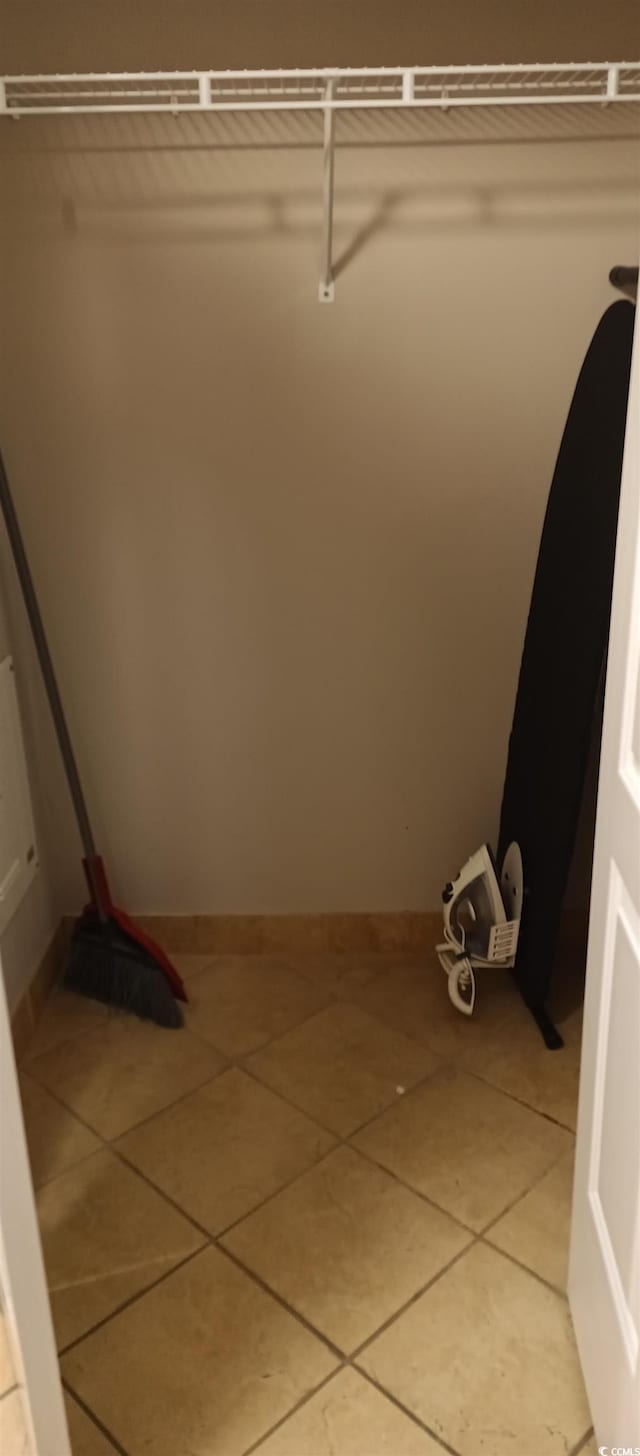 walk in closet featuring light tile floors